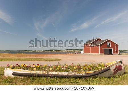 Flowerbed and building on Atlantic shore in North Rustico, Prince Edward Island, Canada.