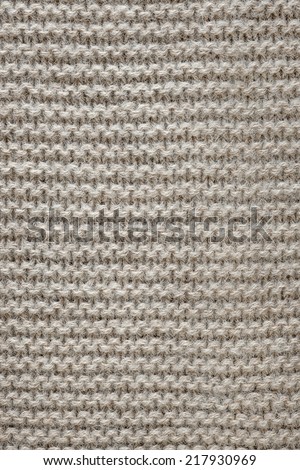 Knit texture of undyed natural brown wool knitted fabric with garter stitch pattern as background