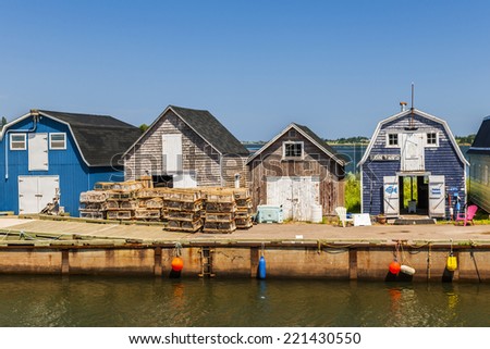 CAVENDISH, PRINCE EDWARD ISLAND, CANADA - JULY 15 2013: Fishing pier with buildings and lobster traps shown on July 15, 2013 in Cavendish, Prince Edward Island, Canada