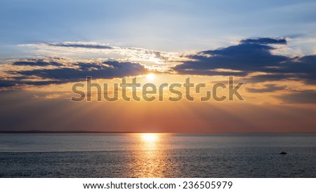 Sunset and sunrays with dramatic sky over Atlantic Ocean in Prince Edward Island, Canada
