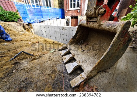 Backhoe scoop at residential home renovation construction site
