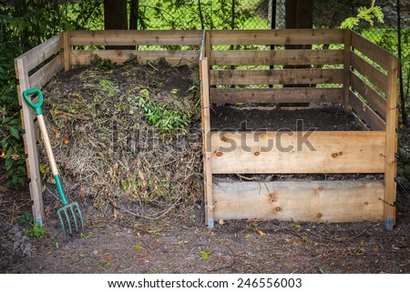 Large cedar wood compost boxes with composted soil and yard waste for backyard composting