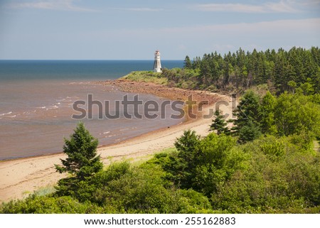 Atlantic beach coast with Cape Jourimain lighthouse, New Brunswick, Canada