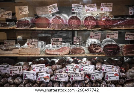 NICE, FRANCE - OCTOBER 2, 2014: Cured meats on display in butcher shop on Rue Pairoliere, a quaint pedestrian shopping street in old Nice.