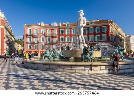 NICE, FRANCE - OCTOBER 2, 2014: Fountain of the sun or Fontaine du Soleil with statue of Apollo at Place Massena is one of the city\'s many tourist attractions.