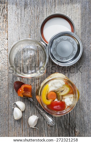 Home preserving mixed vegetables by pickling in glass canning jars