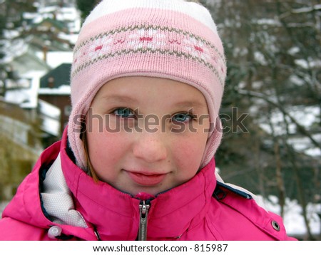 Portrait of a young girl in winter hat outside