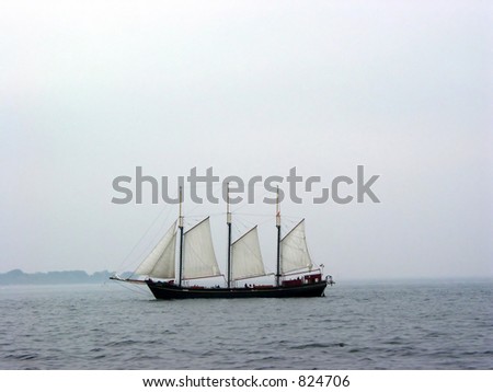 Tall ship sailing on a foggy day