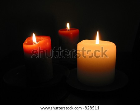 Three candles burning in the dark