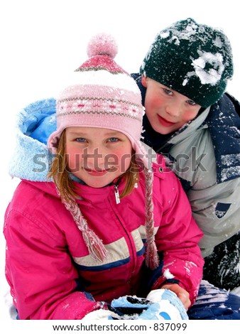 Boy and girl having fun in the fresh white snow