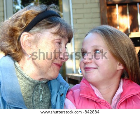 Grandmother and granddaughter looking at each other and smiling