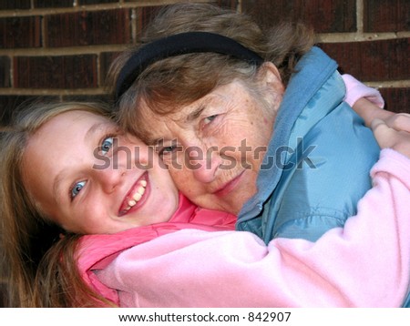 Grandmother and granddaughter hugging and smiling