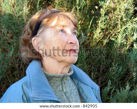 Portrait of elderly woman looking up with the expression of hope on her face
