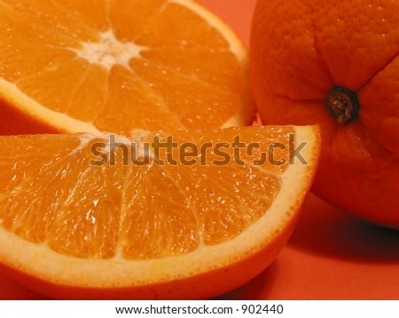 Fresh oranges on orange background, closeup