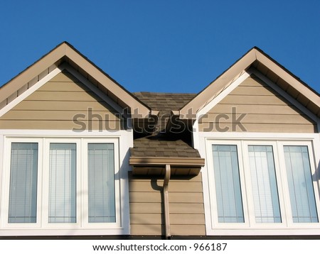 Detail of a brand new house on a bright blue sky background