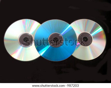 Three compact disks on black background