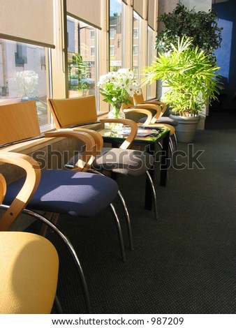 Row of brightly colored chairs in a doctor's office on sunny morning