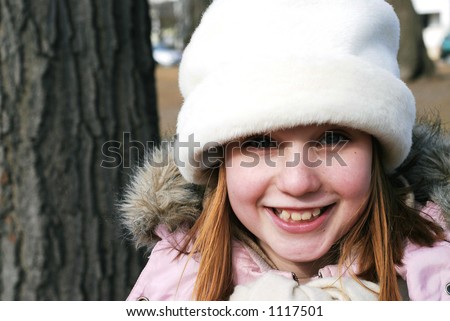 Young girl in winter hat smiling