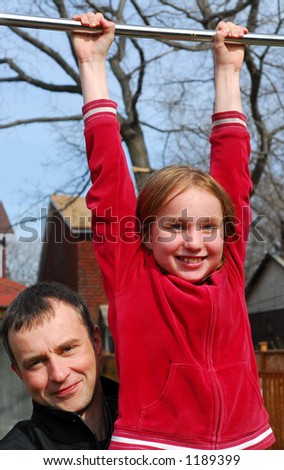 Father and daughter having fun in a backyard