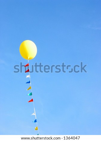 Yellow balloon flying in the blue sky