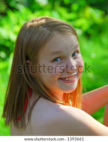 Portrait of a smiling young girl in summer