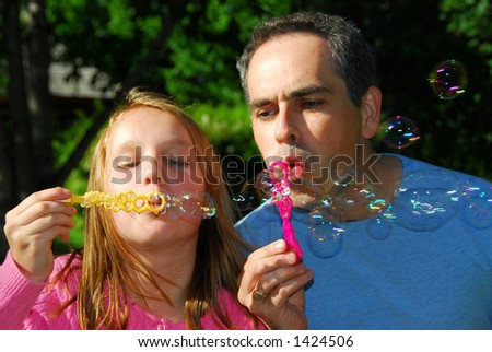 Happy family blowing soap bubbles