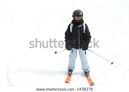 Young girl skiing downhill