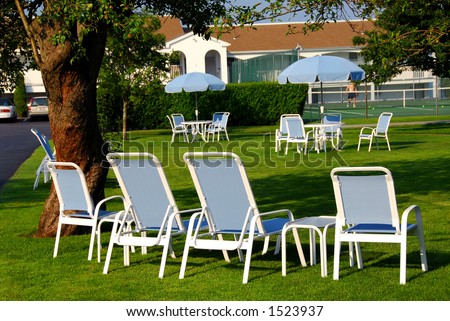 Patio furniture on the lawn in front of luxury hotel