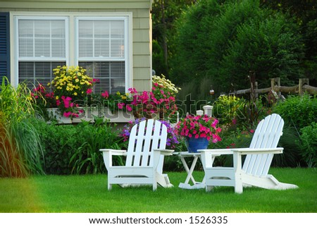 Two lawn chairs in a beautiful garden