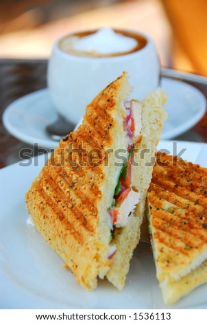 Grilled chicken sandwich and a cup of coffee