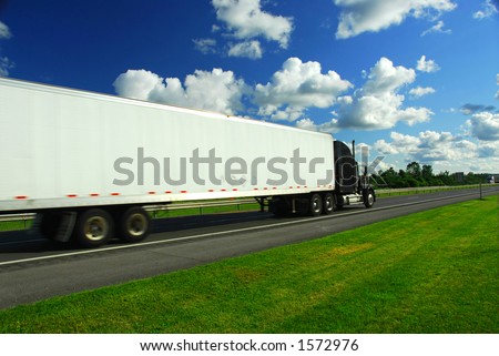 Fast moving truck on highway, blurred because of motion
