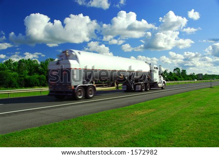 Speeding truck delivering gasoline on highway blurred because of motion