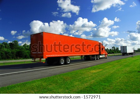 Bright red truck on road, blurred because of fast motion