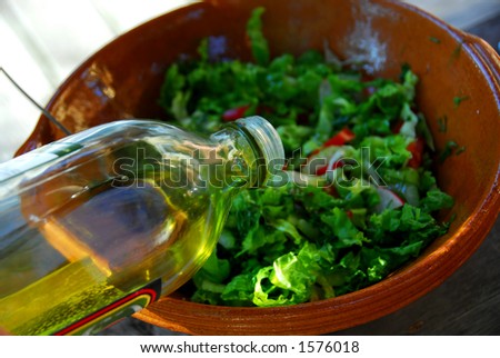 stock-photo-olive-oil-being-poured-into-garden-salad-for-salad-dressing-1576018.jpg