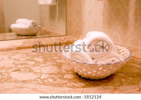 Towels in luxury bathroom with beige marble counter