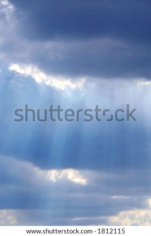 Cloudy stormy sky with sun ray breaking through
