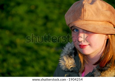 Portrait of a young smiling girl in fall clothes outside