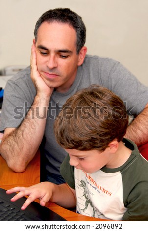 Father teaching his son to work on a computer
