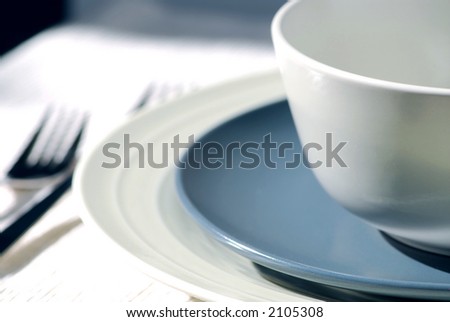 Dinner place setting with plates and soup bowl