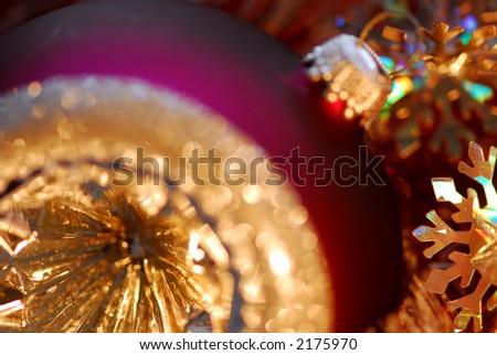 Closeup of purple christmas tree glass ball. Shallow dof, focus on the snowflake.
