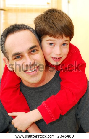Portrait of smiling father and son inside