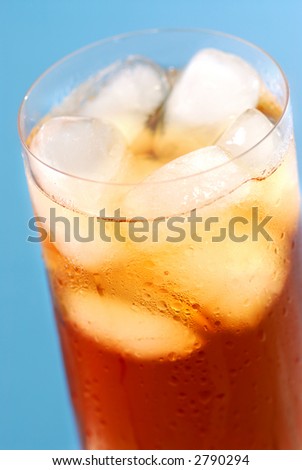Glass of regular cold iced tea with water drops on surface