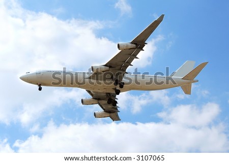 Airplane flying in blue sky with clouds, no logos