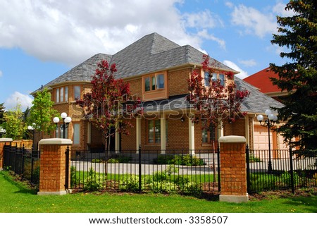 Big luxury residential house with iron fence