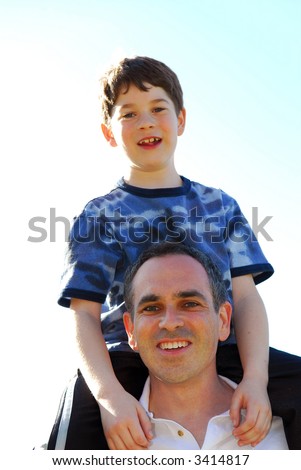 Portrait of father and son playing outdoors