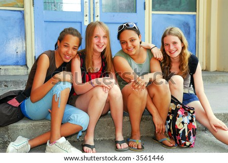 stock photo Portrait of a group of young smiling school girls sitting on 