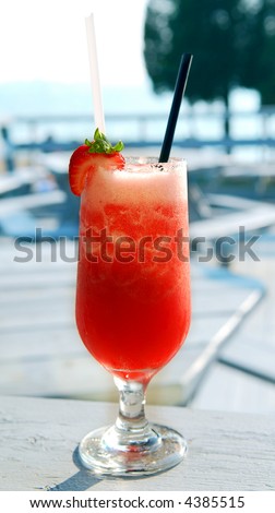 Strawberry daiquiri cocktail served in a cold glass on a patio