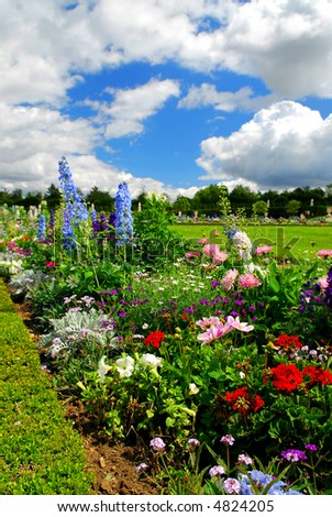 Blooming colorful flowerbeds in Versailles gardens, France.