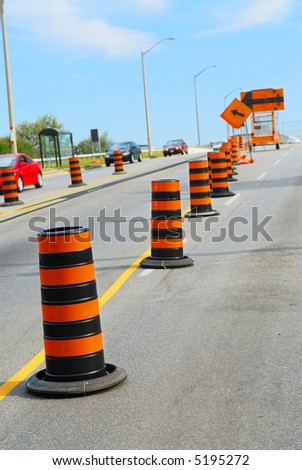 Road construction signs and cones on city street