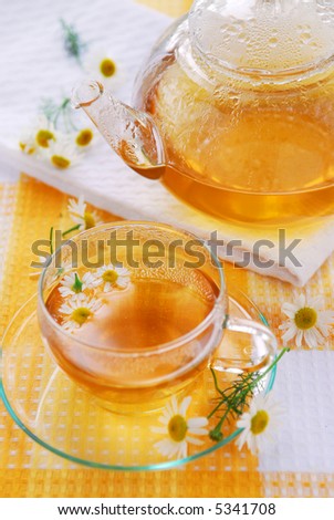 Teacup and teapot with soothing chamomile tea